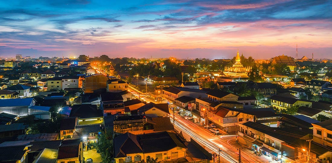 Vientiane at dusk, with the golden Pha That Luang stupa above the rooftops